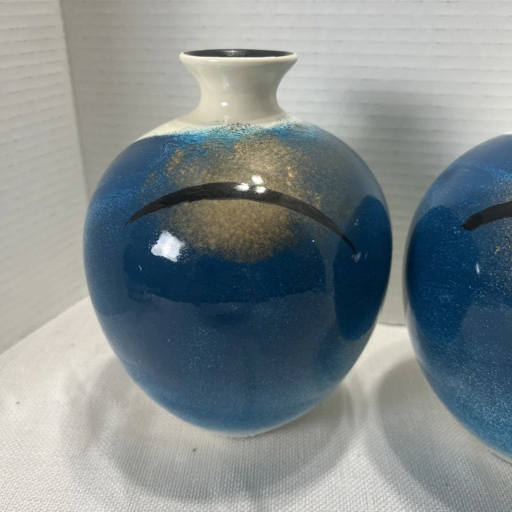 Pair of decorative blue, gold, black and Cream ceramic bottle vases
